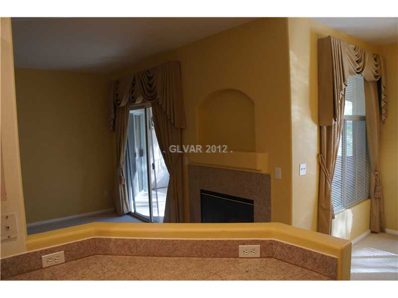 2050 West Warm Springs Road, Unit 3921 Henderson, NV 89014 - Photo 5 of 12 Den. Kitchen overlooks dining are and family room with fireplace.