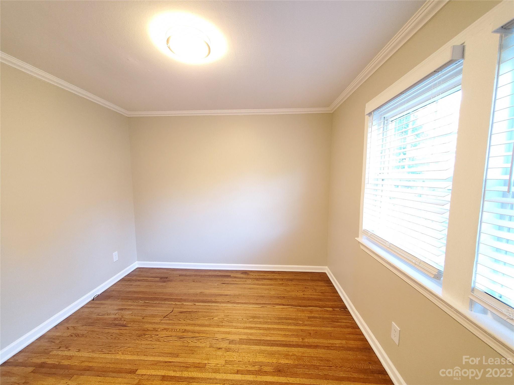 1545 Walton Road, Unit 1547 Charlotte, NC 28208 - Photo 17 of 25 a view of room with window and wooden floor