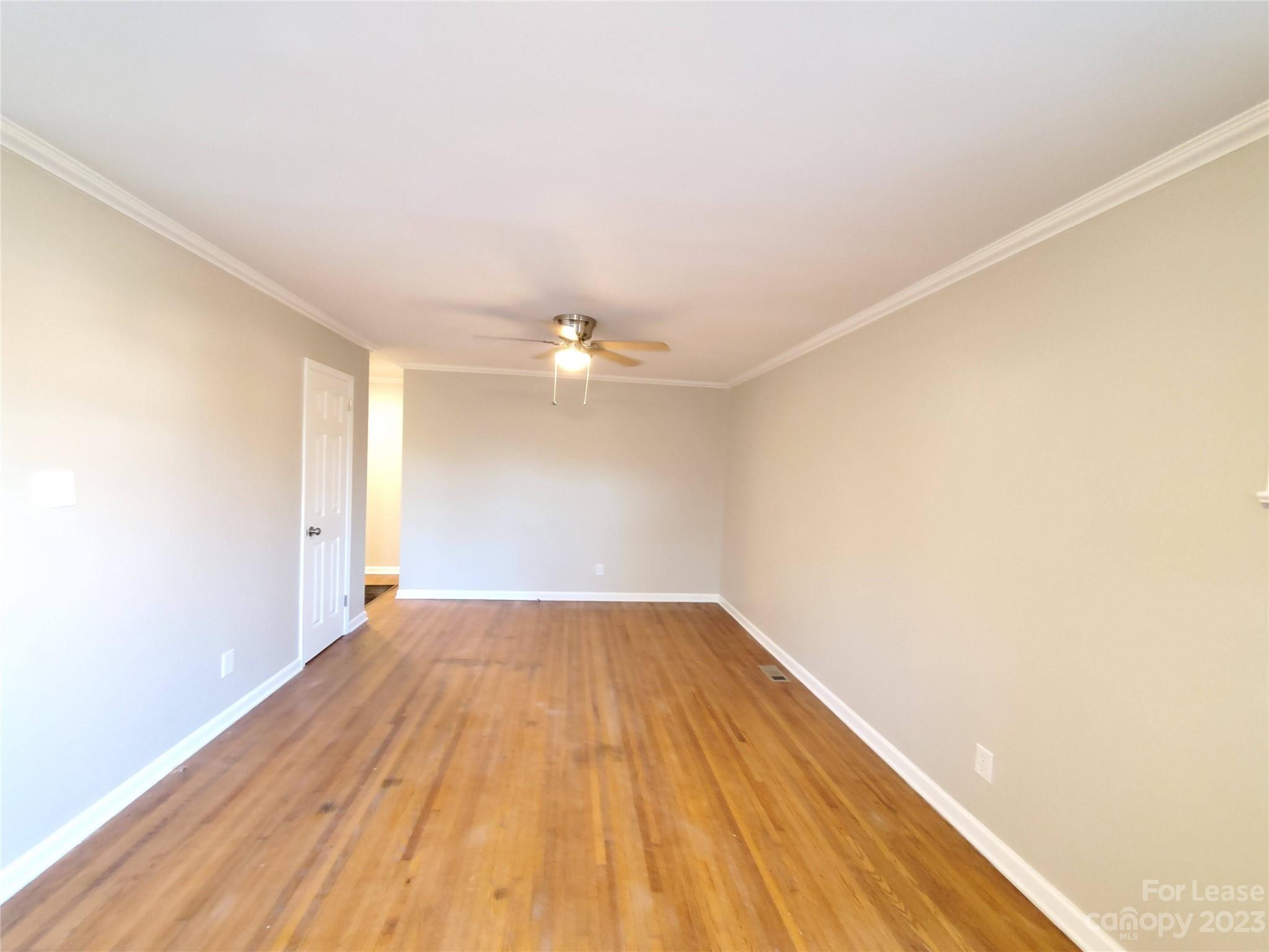 1545 Walton Road, Unit 1547 Charlotte, NC 28208 - Photo 22 of 25 an empty room with wooden floor and windows