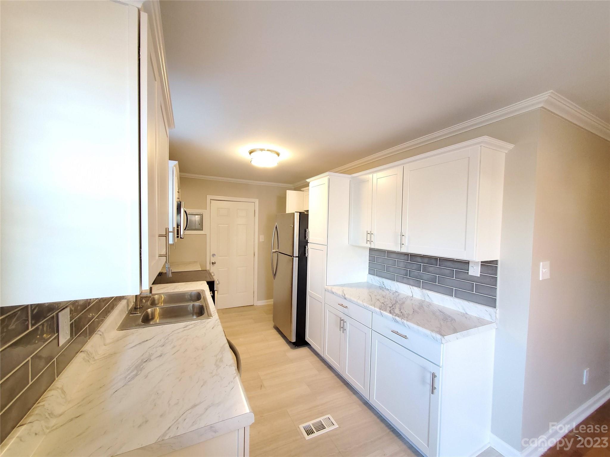 1545 Walton Road, Unit 1547 Charlotte, NC 28208 - Photo 6 of 25 a bathroom with a tub sink and mirror