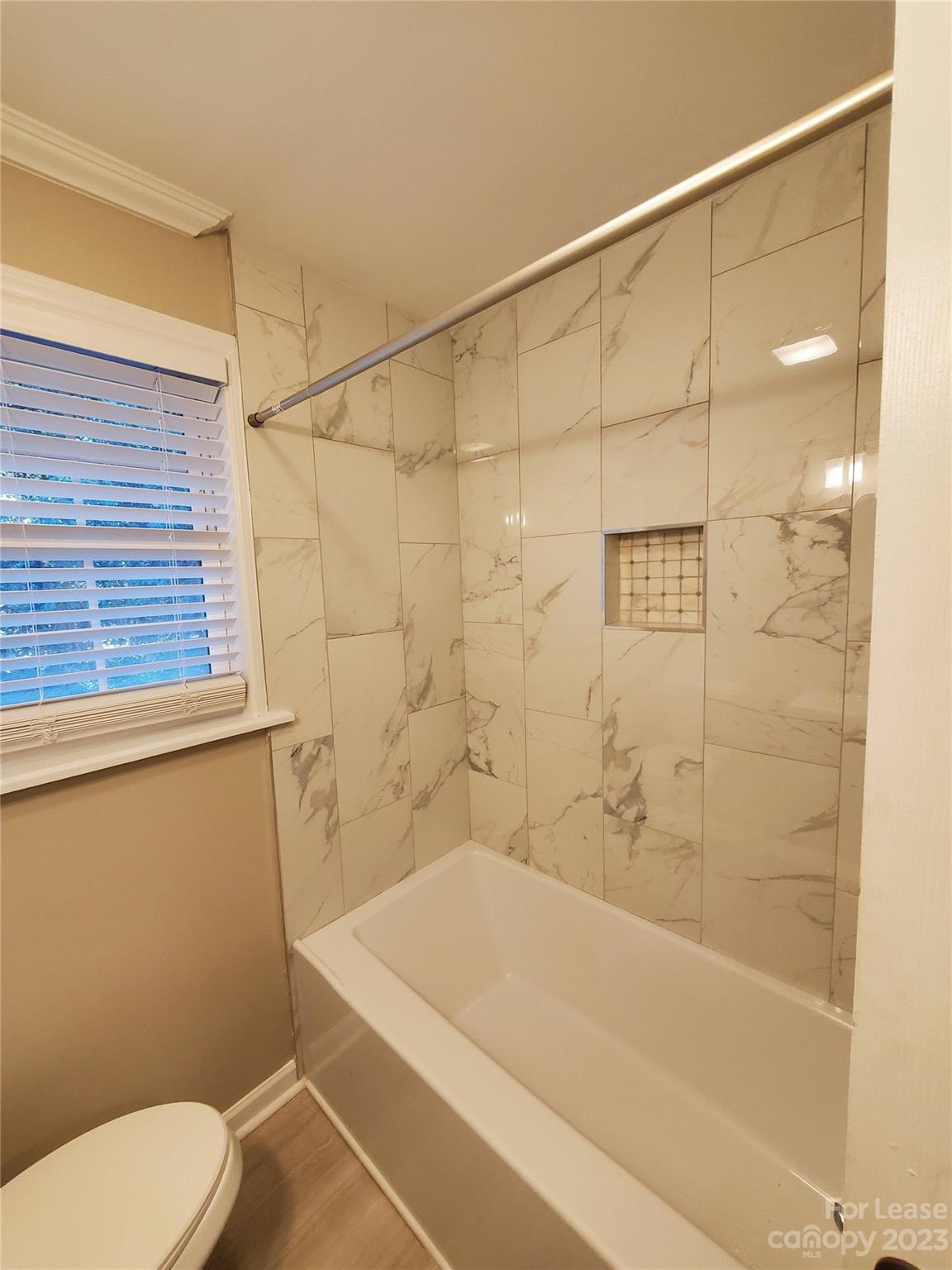 1545 Walton Road, Unit 1547 Charlotte, NC 28208 - Photo 10 of 25 a bathroom with a shower and a toilet