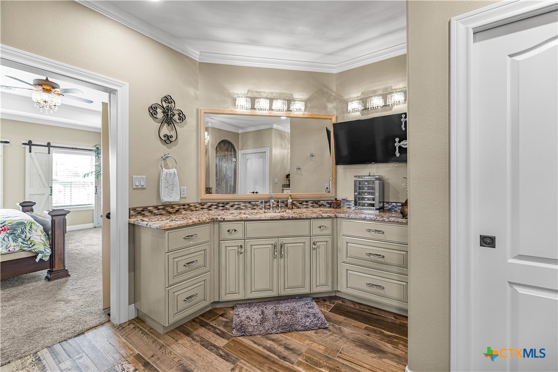 254 Sendera Loop Victoria, TX 77904 - Photo 31 of 48 a spacious bathroom with a granite countertop sink and a mirror
