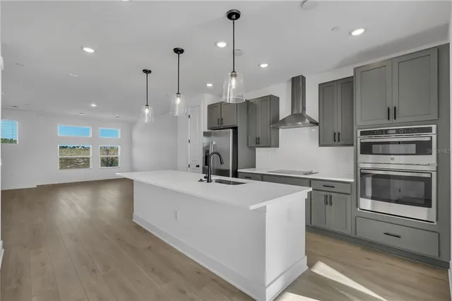 a kitchen with a sink a stove and a refrigerator