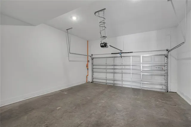 a front view of a house with garage and parking