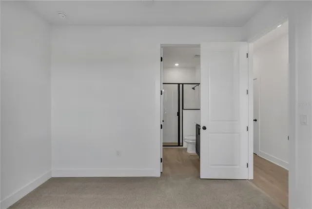 a bathroom with a sink a toilet a mirror and shower