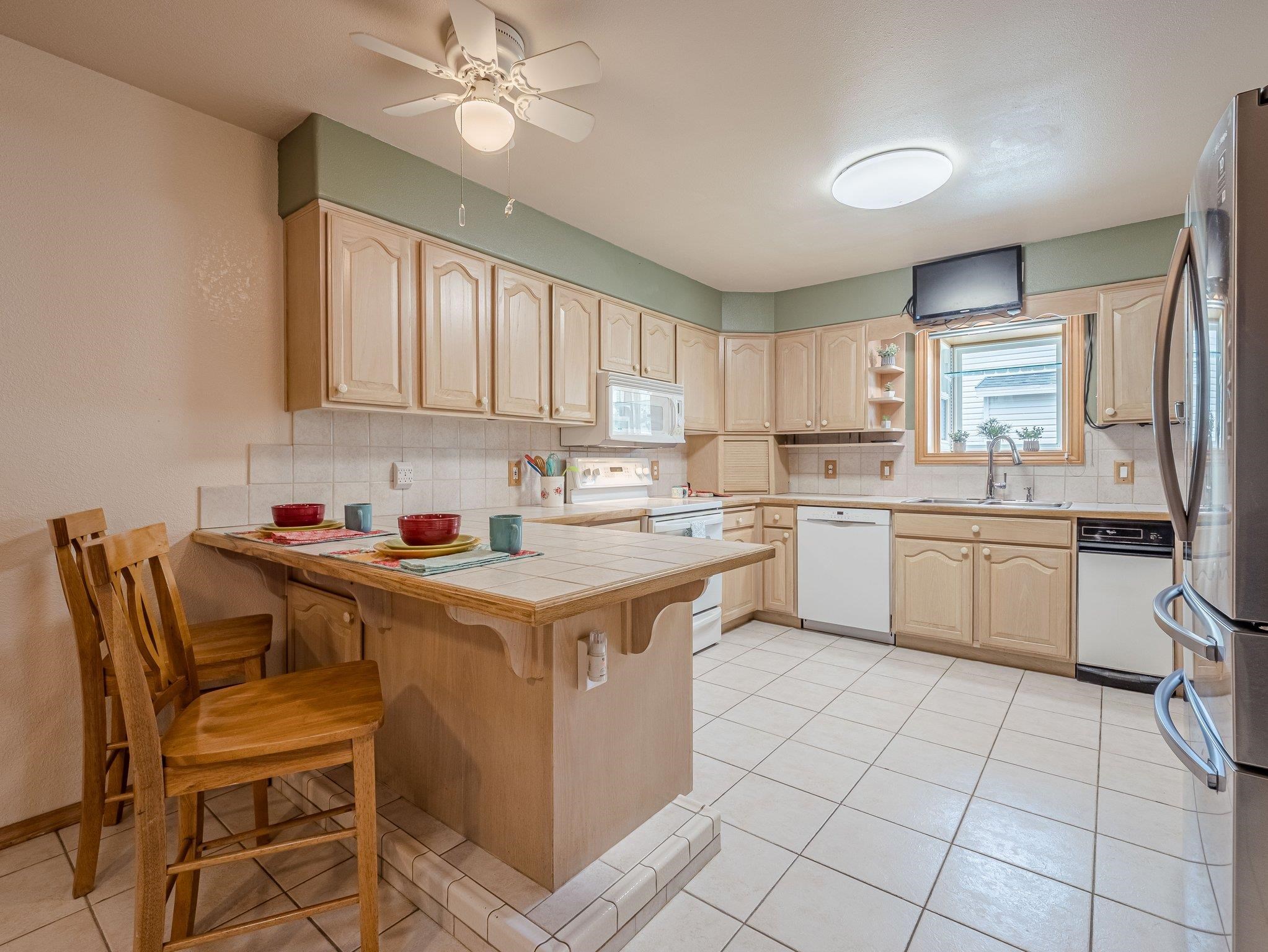 526 North Oak Street Fruita, CO 81521 - Photo 11 of 42 a kitchen with a sink a stove cabinets and a window