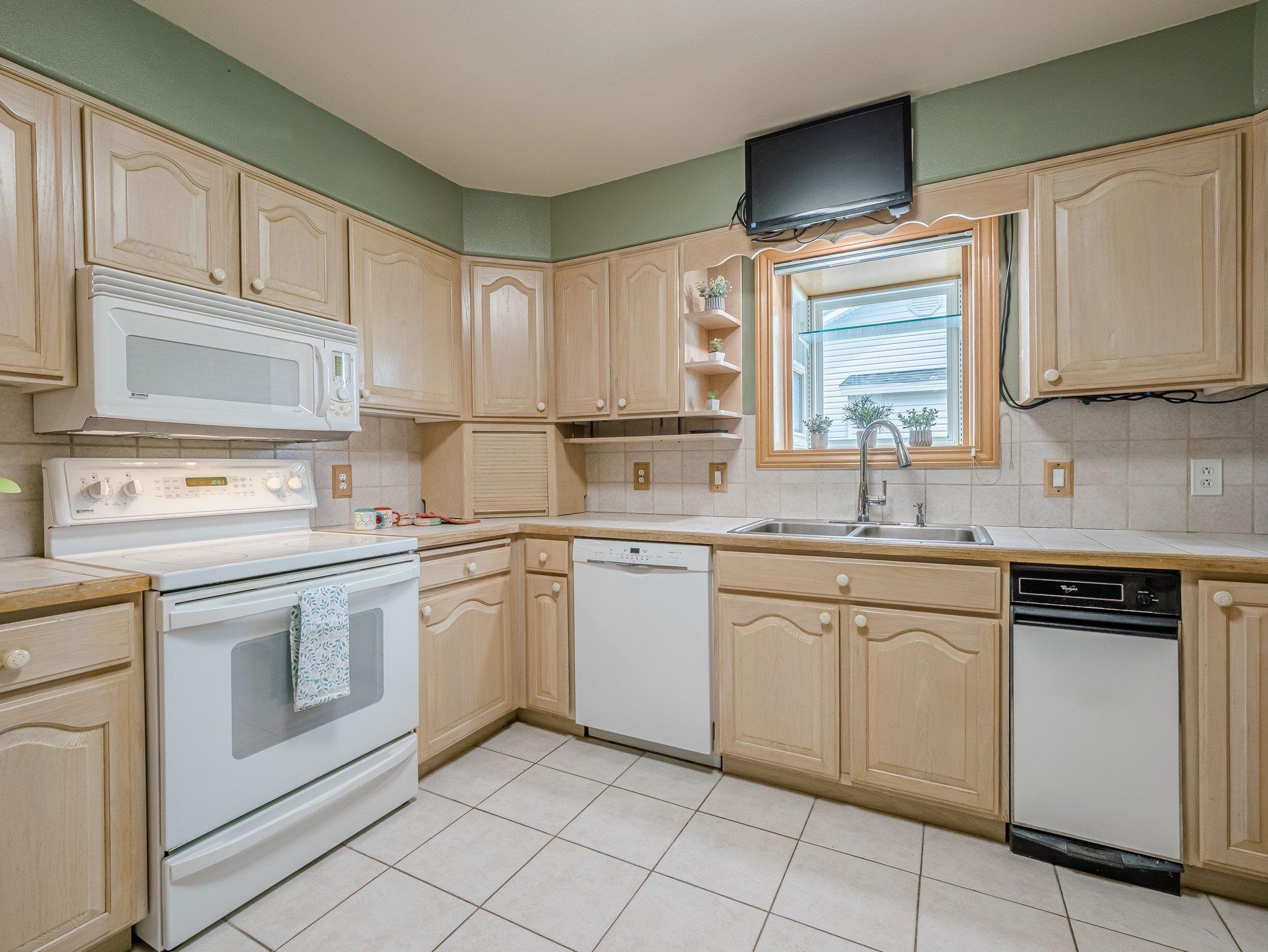 526 North Oak Street Fruita, CO 81521 - Photo 12 of 42 a kitchen with white cabinets white appliances and sink