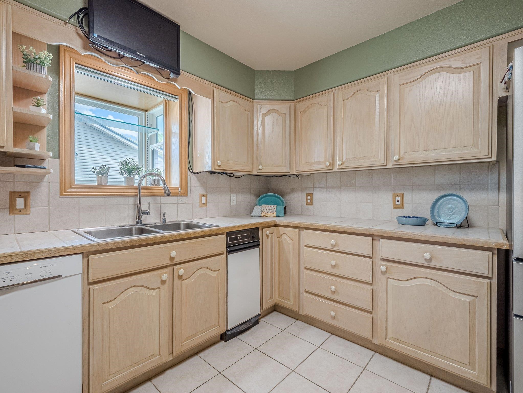 526 North Oak Street Fruita, CO 81521 - Photo 14 of 42 a kitchen with cabinets appliances a sink and a window