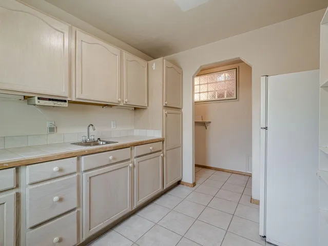 a kitchen with granite countertop white cabinets and sink
