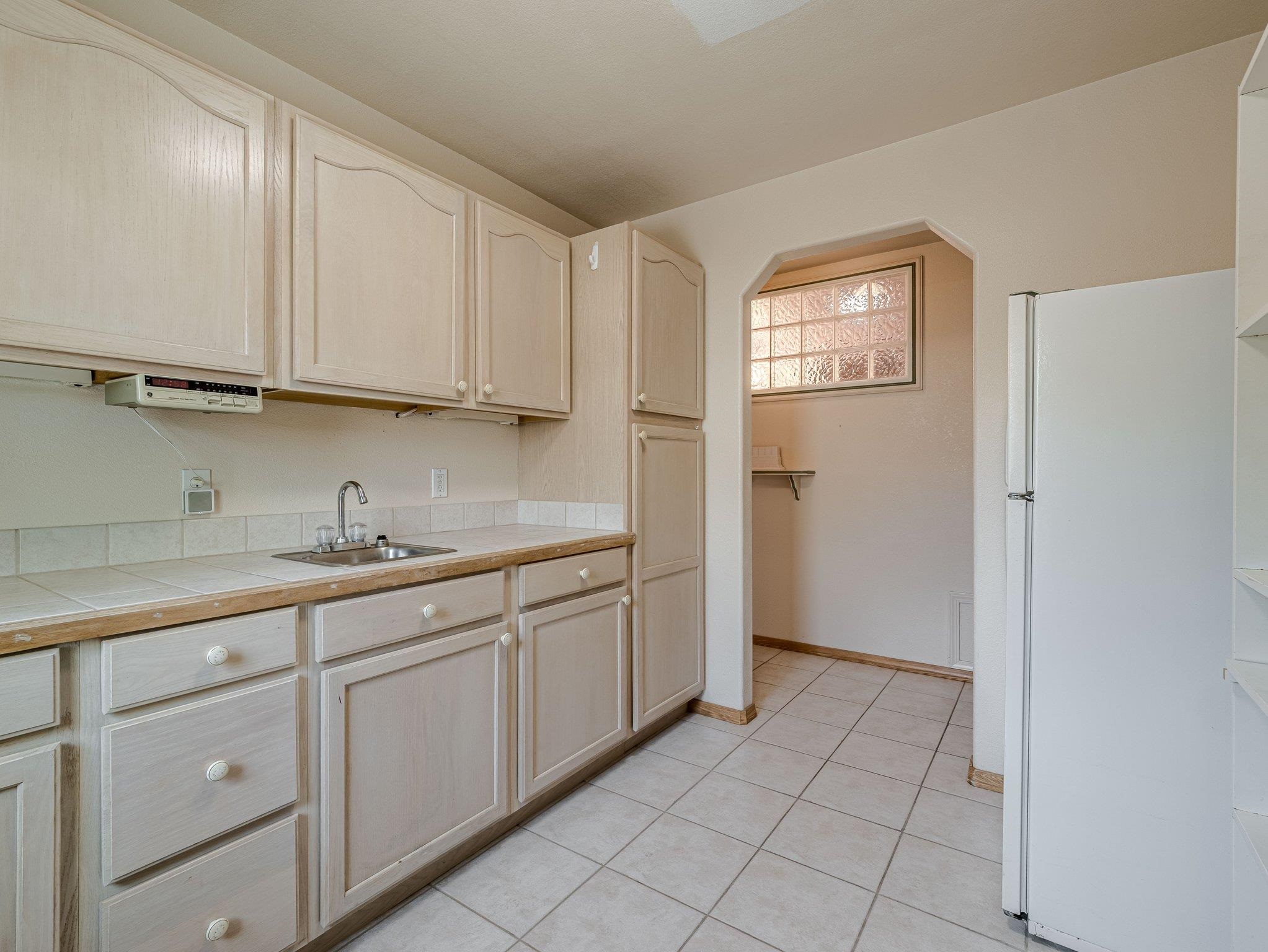 526 North Oak Street Fruita, CO 81521 - Photo 16 of 42 a kitchen with granite countertop white cabinets and sink