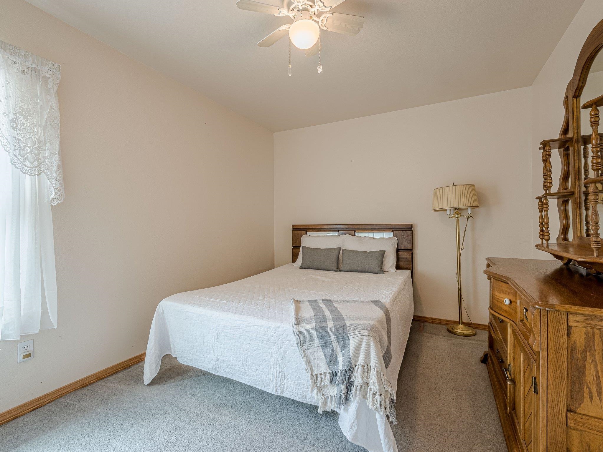 526 North Oak Street Fruita, CO 81521 - Photo 20 of 42 a bedroom with a bed and a chandelier