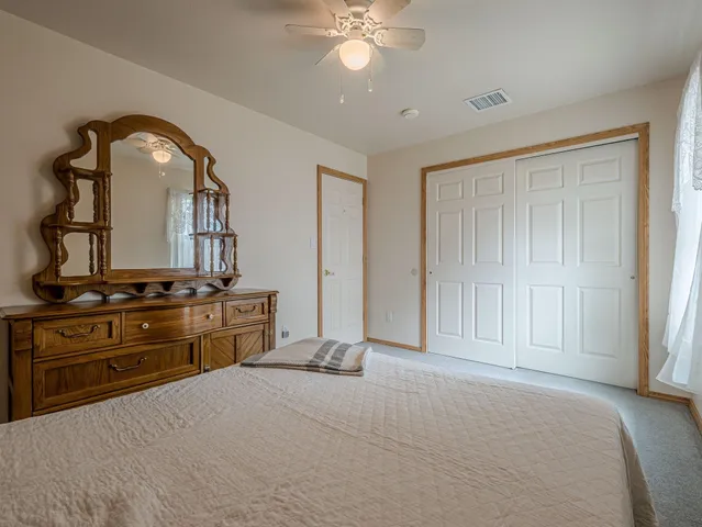 a bedroom with a bed and a dresser