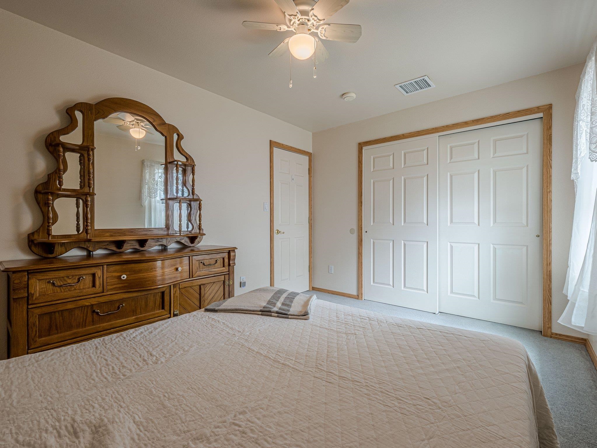 526 North Oak Street Fruita, CO 81521 - Photo 21 of 42 a bedroom with a bed and a dresser
