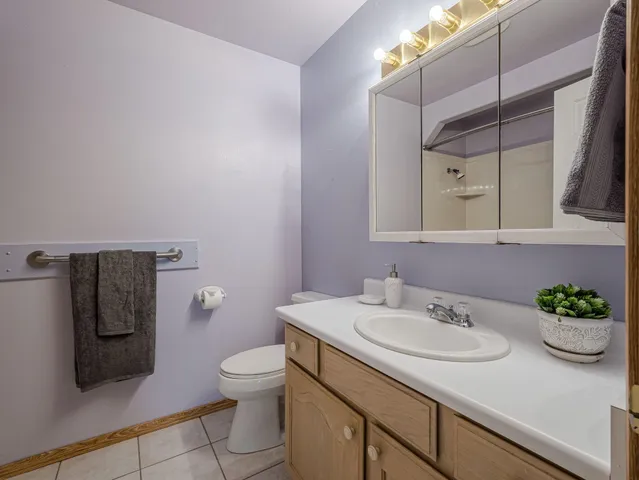 a bathroom with a sink toilet and a mirror