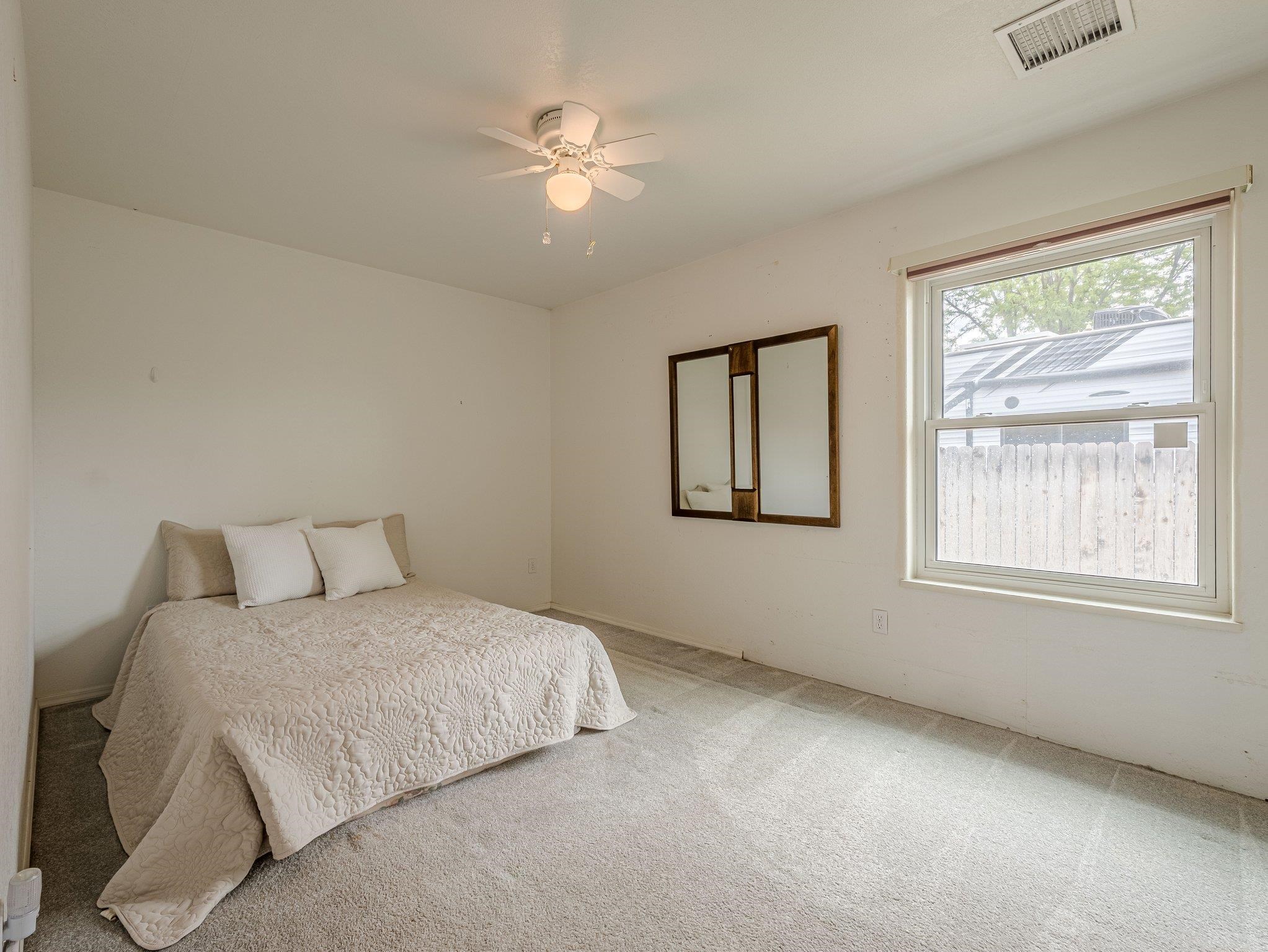 526 North Oak Street Fruita, CO 81521 - Photo 24 of 42 a bedroom with a large bed and a window