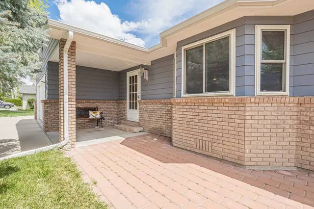 a backyard of a house with outdoor seating