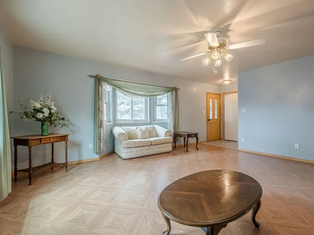 a living room with furniture and a chandelier