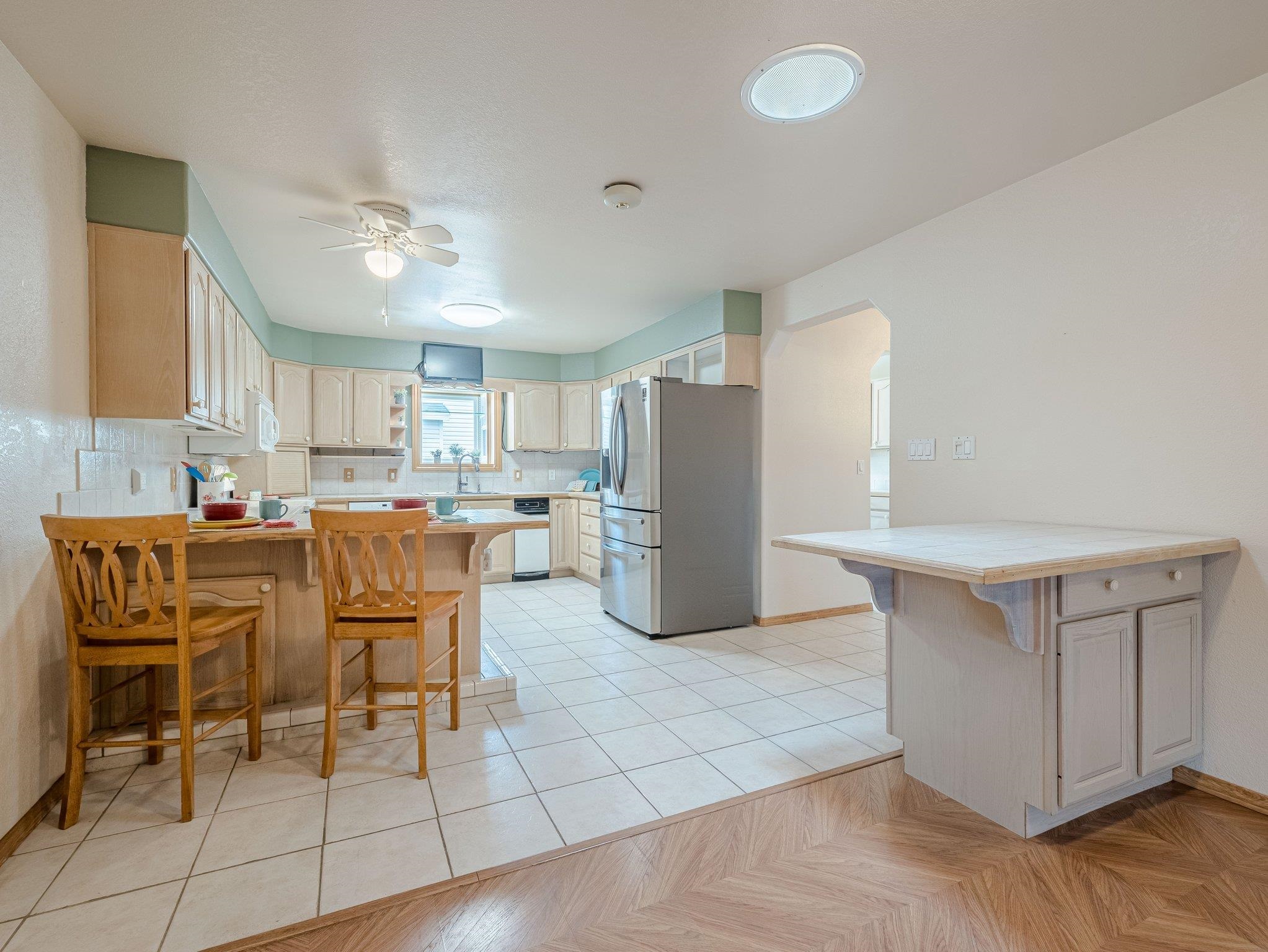 526 North Oak Street Fruita, CO 81521 - Photo 10 of 42 a kitchen with a dining table chairs and refrigerator