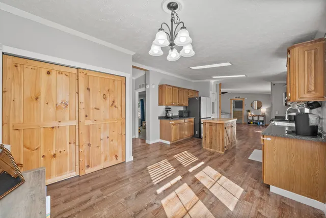 a kitchen with stainless steel appliances granite countertop a sink a stove and a microwave