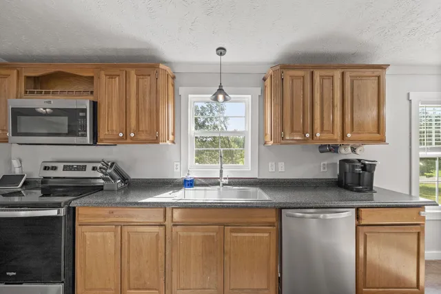 a view of a kitchen with stove top oven