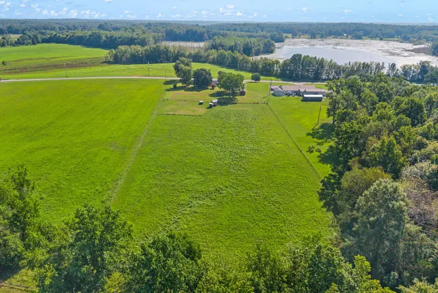 an aerial view of a house with a yard basket ball court and outdoor seating