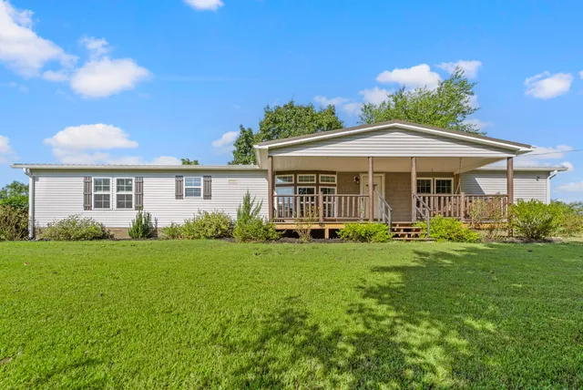 front view of a house with a window and a bench