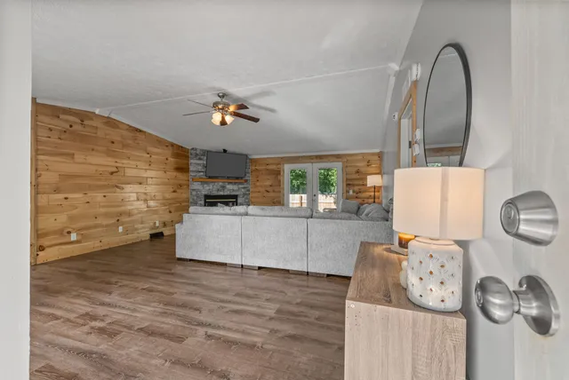 a view of a livingroom with furniture wooden floor and a ceiling fan