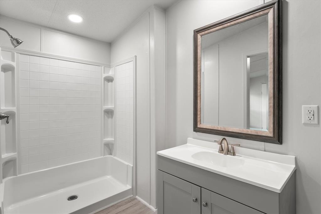 367 Box Road Gun Barrel City, TX 75156 - Photo 15 of 25 a bathroom with a bath tub sink mirror and shower