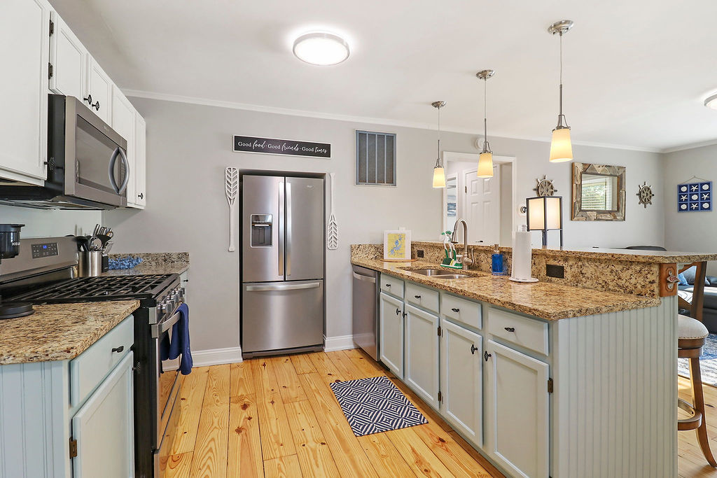 3 North Maple Avenue Fox Lake, IL 60020 - Photo 7 of 24 a kitchen with stainless steel appliances granite countertop a sink a stove a refrigerator and cabinets
