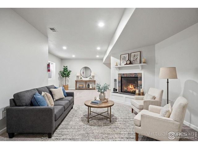 a living room with furniture a rug and a fireplace
