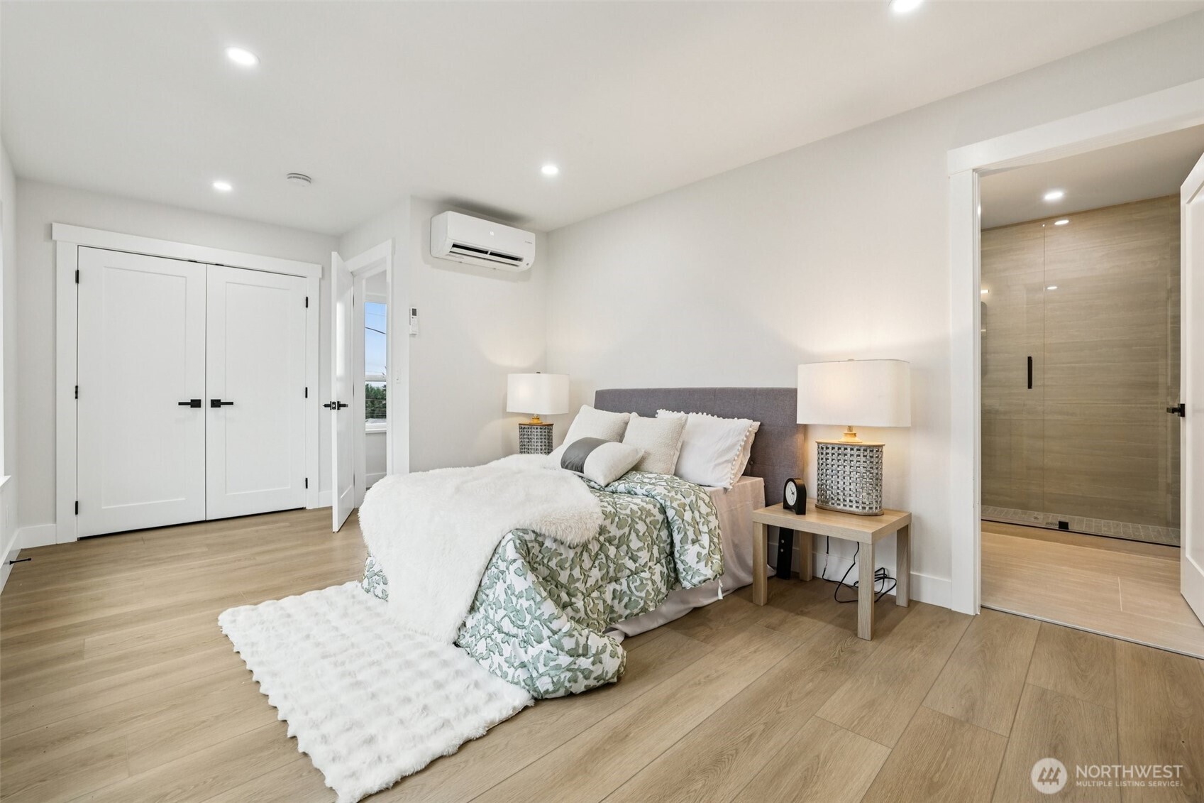 7719 Renton Avenue South, Unit B Seattle, WA 98118 - Photo 22 of 35 a spacious bedroom with a bed and a table