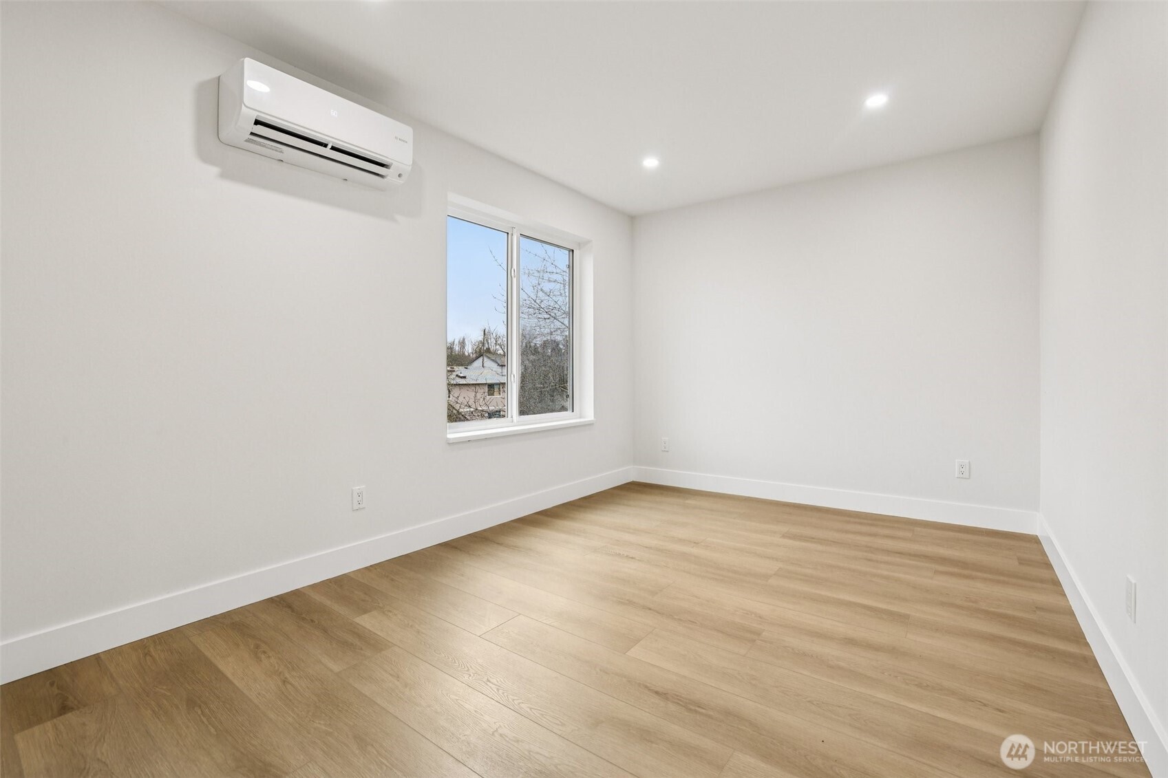 7719 Renton Avenue South, Unit B Seattle, WA 98118 - Photo 27 of 35 an empty room with wooden floor and windows