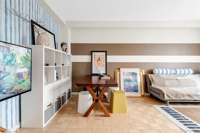 a view of a hallway with workspace and a window