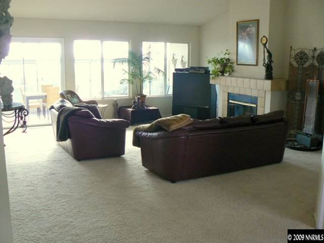 905 University Place Reno, NV 89512 - Photo 4 of 9 a living room with fireplace furniture and a floor to ceiling window