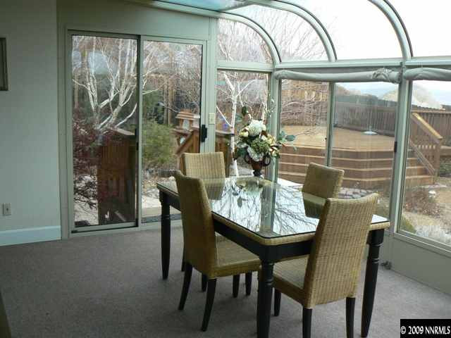 905 University Place Reno, NV 89512 - Photo 6 of 9 a dining room with furniture a chandelier and wooden floor