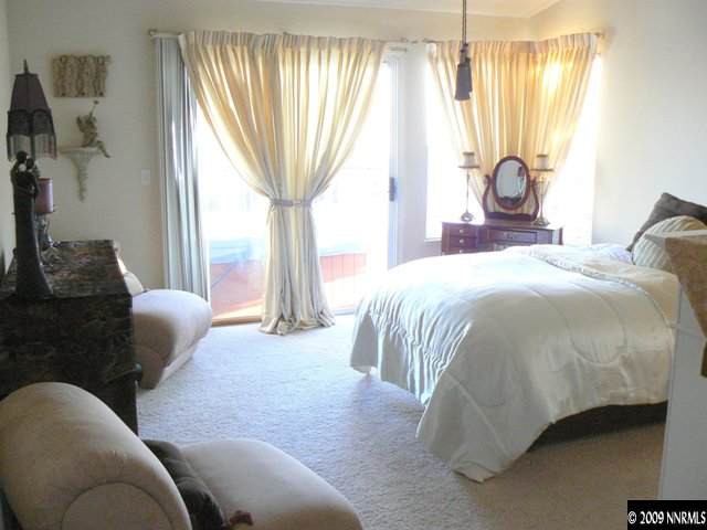 905 University Place Reno, NV 89512 - Photo 8 of 9 a bedroom with a bed and a chandelier