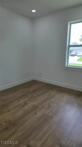 a kitchen with cabinets and wooden floor
