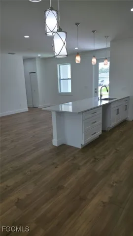 an empty room with wooden floor cabinet and closet