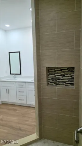 a bathroom with a sink mirror and vanity