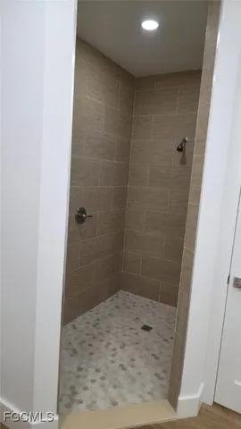 a large white kitchen with a large window