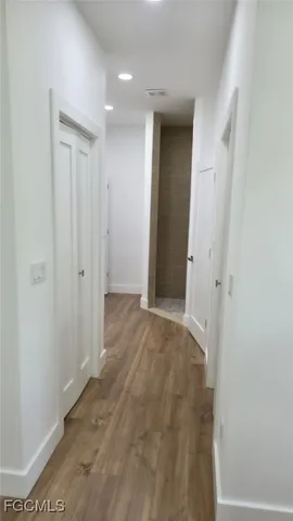 a bathroom with a sink mirror and tub