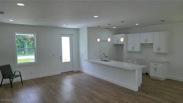 a view of a room with wooden floor