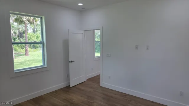 a large kitchen with stainless steel appliances a large counter top a sink and a dishwasher