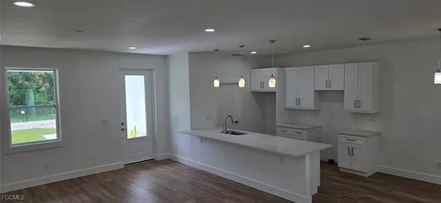 a view of a room with wooden floor