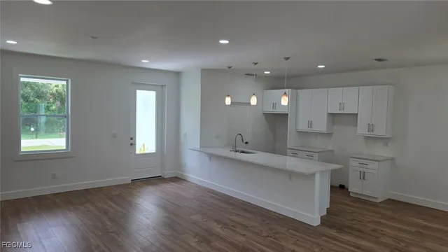 a view of a yard in front of a house with large trees