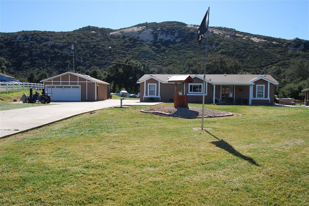 19547 Hidden Glen Road Alpine, CA 91901 - Photo 1 of 1 a front view of a house with garden