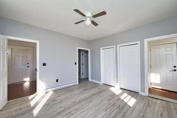 a view of an empty room and wooden floor