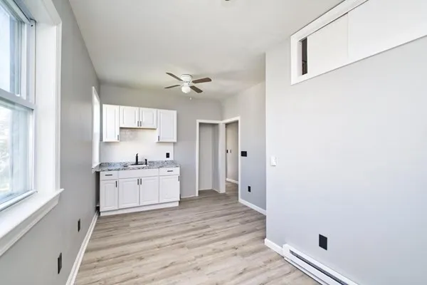 a kitchen with a stove a sink and a refrigerator