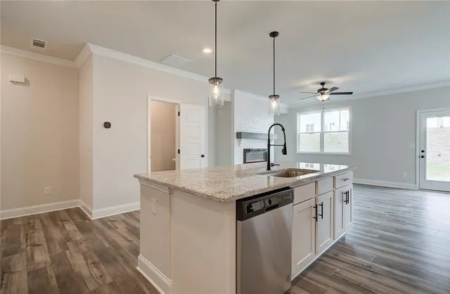 a kitchen with sink stove and refrigerator