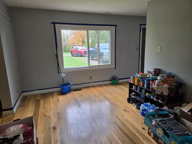 a room with wooden floor and shoes